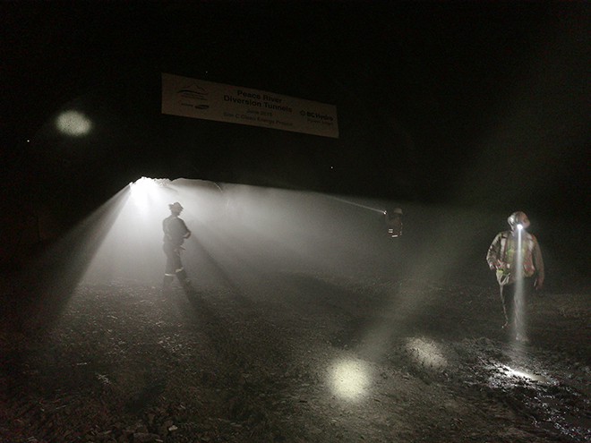 Crews  inspect the opening that connects the inlet and outlet excavations area shortly after breakthrough in Tunnel #1.