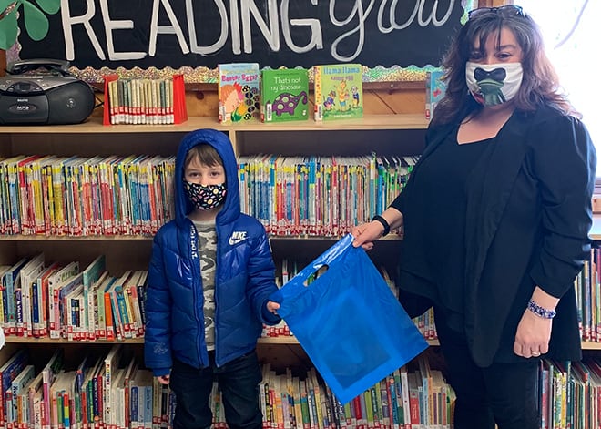 StoryTime patron, Oliver McCormick, receiving his craft package from Library Programmer, Shellie Howard, at the Hudson’s Hope Public Library.